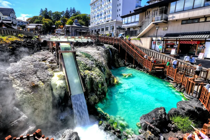 Turquoise hot spring water flowing through the Yubatake at Kusatsu Onsen